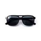 Occhiali da sole zo-oz stile aviator modello hop nero lucido per bambini 6-12 anni piegati e fotografati dall'alto.